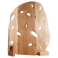 a wooden sculpture with holes in it