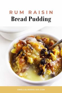 a white bowl filled with bread pudding on top of a table next to a spoon