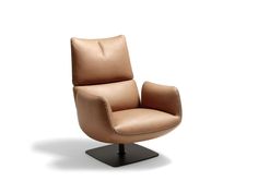 a tan leather chair on a black metal base with a white back ground and light brown upholster