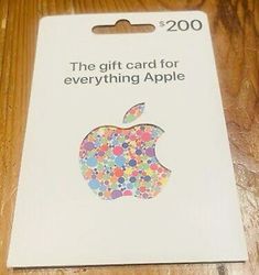 the gift card for everything apple has been placed on top of a wooden table,