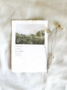 a card with flowers on top of it next to a piece of paper that says,