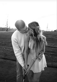 black and white photo of couple holding golf club