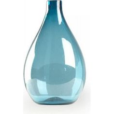 a blue glass vase sitting on top of a white table