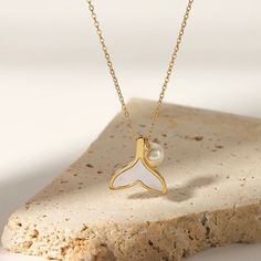 A captivating blend of elegance and whimsy, this Mermaid Necklace features a delicate gold chain adorned with a shimmering pearl and a playful mermaid tail pendant. Composition: Material: High-Quality Stainless Steel-Plated 18k Gold Length 16 “ + 3” extension water resistant 💧 (No discoloration, No Tarnishing) Hypoallergenic and skin-friendly. NOTE: you can swim, sleep and sweat with this piece. Our jewelry does not tarnish, is resistant to water and sweat. No more green skin! (No discoloration Delicate Gold Chain, Fine Gold Necklace, Green Skin, Whale Tail, Mermaid Necklace, Stainless Steel Plate, Mermaid Tail, Earrings Collection, Instagram Shop