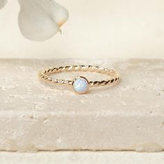 Details: - Available in 14k gold fill or sterling silver - 1.6mm Twist Band - 4mm Kyocera White Opal Since every piece is handmade, you may experience a slight color difference in places where the metal has been soldered making every piece truly unique. F O L L O W * U S Like it or love it? We want to hear from you! Follow us on Instagram @ajajewelry Opal Stacking Ring, Ring Minimal, Rope Rings, Minimal Ring, Braided Ring, Simple Ring, Twisted Band, Textured Ring, Ring Simple