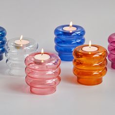 several different colored candles sitting next to each other