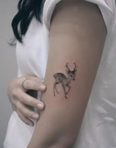 a woman with a deer tattoo on her arm