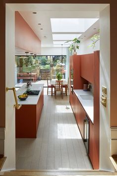 an open kitchen with orange cabinets and white counter tops