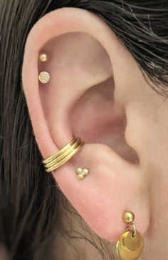 "This clicker hoop is made to create the appearance of three hoops with only one piercing. It fits best worn in a conch piercing in the space where the three hoops can rest toward the bottom of the conch. The hinge is placed for it to fit for the LEFT ear, though if your piercing is in the right ear (as is the case with the model) the hoop can be threaded backwards through the piercing the way a labret post would be threaded. The hinge is attached to the center hoop which is 10mm interior diamet Daith And Conch Earrings, Thick Conch Hoop, Stretched Septum Jewelry, Conch Hoop Jewelry, Coin Slot Piercing, Conch Piercing Hoop, Gold Conch Hoop, Conch Hoop, Conch Jewelry