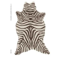 a zebra print rug is shown in brown and white colors, with the shape of an animal's head