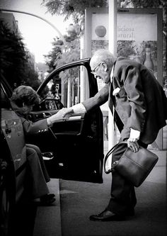 an old man opening the door of a car