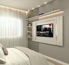 there is a television mounted on the wall above the bed in this modern style bedroom