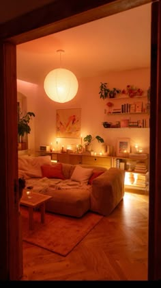 a living room filled with furniture and lit candles