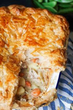 a chicken pot pie is cut in half on a blue and white checkered cloth