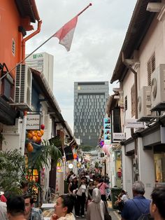 many people are walking down an alley way