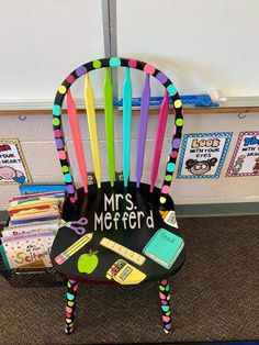 a chair made to look like a teacher's desk with school supplies on it