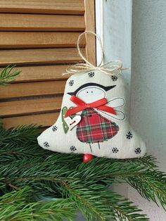 a christmas ornament hanging from the side of a tree