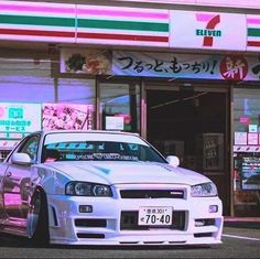 a white car parked in front of a store