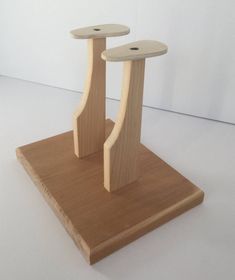 two small wooden sculptures sitting on top of a table