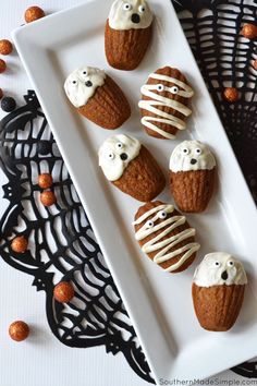 halloween cupcakes with white frosting and spooky eyes on a plate