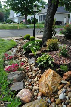 a rock garden is shown in front of a house