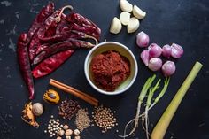 various vegetables and spices on a black surface