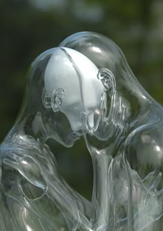 a glass sculpture of two people kissing each other