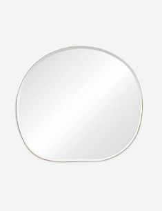 an oval mirror on a white wall