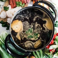 broccoli, carrots and other vegetables in a pot with the words world's best broth