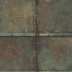 an old rusty metal door with rivets and screws on it's sides