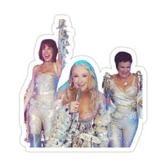 three women in sequins and one is holding a microphone