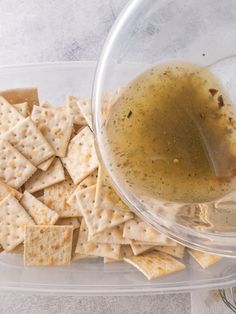 a glass bowl filled with crackers and olive oil