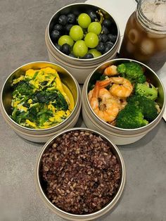 four bowls filled with different types of food next to a jar of fruit and vegetables