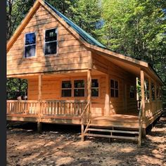 a small wooden cabin in the woods surrounded by trees