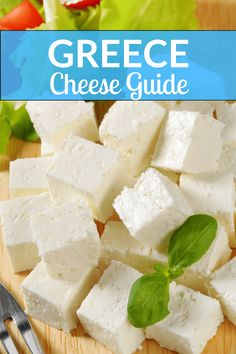 cheese cubes on a cutting board with basil leaves