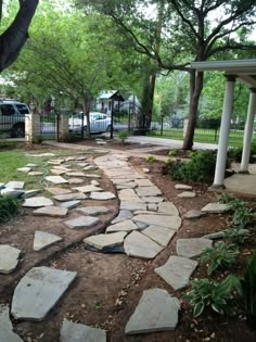 a stone path in the middle of a yard