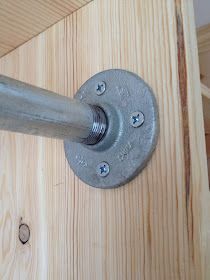 a close up of a metal handle on a wooden door