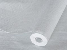 a roll of white sheer fabric on top of a bed sheet with the end rolled up