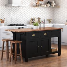 a kitchen island with two stools in front of it