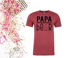 a t - shirt with the words papa bear on it next to some confetti