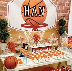 a basketball themed birthday party with orange and white desserts, cupcakes, and candy