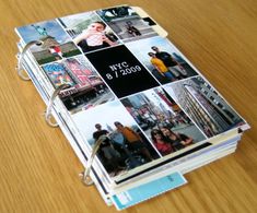 a book with pictures on it sitting on top of a wooden table