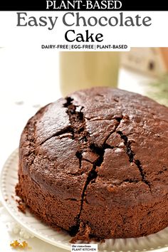 a chocolate cake sitting on top of a white plate next to a glass of milk