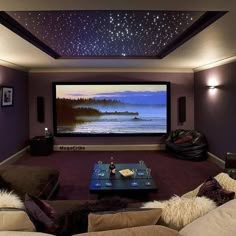 a living room with couches and a flat screen tv on the wall in front of it