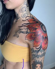 a woman with tattoos on her arm and chest