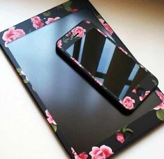 two cell phones sitting on top of each other with pink flowers all over the screen