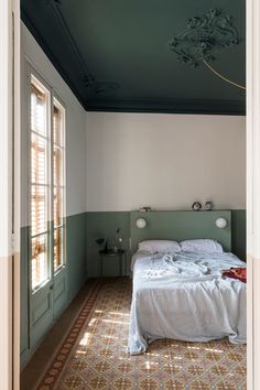 a bed sitting in the middle of a bedroom next to an open door and window