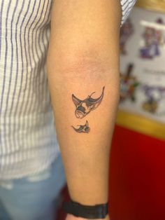 a woman's arm with a small tattoo of a bird on the left forearm