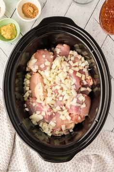 the ingredients for this slow cooker meal include onions, meat and seasonings in small bowls