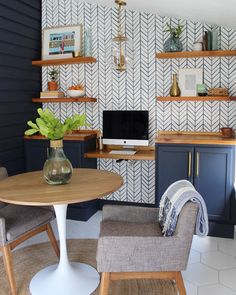 a living room filled with furniture next to a wall covered in bookshelves and shelves